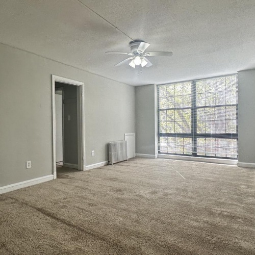 a room with a ceiling fan and a window