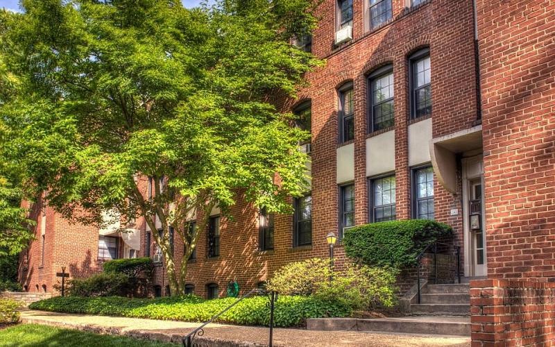 a brick building with trees in front